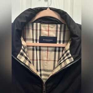 Burberry coat. Black, quilted, with classic pattern inside.